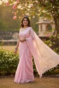 Woman wearing sheer MulMul cotton saree in pastel pink